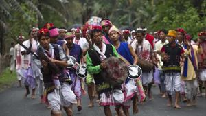 Members of Karbi tribe in traditional attire perform a warrior dance as they take part in a religious procession during the traditional festival Members of Karbi tribe in traditional attire perform a warrior dance as they take part in a religious procession during the traditional festival