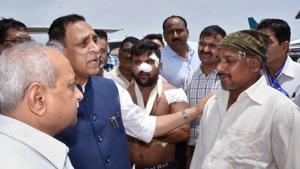 Gujarat chief minister Vijay Rupani interacts with the driver (right) of the bus that was attacked by the militants in J-K.(PTI Photo) Gujarat chief minister Vijay Rupani interacts with the driver (right) of the bus that was attacked by the militants in J-K.(PTI Photo)