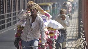 A man wipes sweat form his forehead as he ferries goods in hot weather on his cycle rickshaw across the Old Yamuna bridge in New Delhi.(Gurinder Osan/HT file photo) A man wipes sweat form his forehead as he ferries goods in hot weather on his cycle rickshaw across the Old Yamuna bridge in New Delhi.(Gurinder Osan/HT file photo)