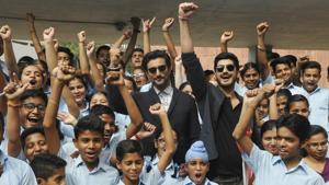 Actor Kunal Kapoor and Mohit Marwaha with school students after an interaction session at Panjab University in Chandigarh.(Karun Sharma/HT Photo)