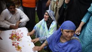 Relatives of police officer Mohammad Ayub Pandith mourn by the coffin with his body at his home in Srinagar.(AFP File Photo) Relatives of police officer Mohammad Ayub Pandith mourn by the coffin with his body at his home in Srinagar.(AFP File Photo)