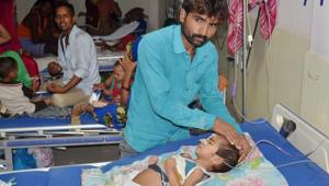 A father attends to his child at the BRD Hospital in Gorakhpur on Friday where at least 30 children died in the past two days.(PTI Photo) A father attends to his child at the BRD Hospital in Gorakhpur on Friday where at least 30 children died in the past two days.(PTI Photo)