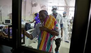 A man leaves a hospital ward with the lifeless body of his one-month-old nephew at Baba Raghav Das Medical College Hospital in Gorakhpur where at least 60 children died in the last week. The deaths coincided with a shortage of oxygen mid-week, after supply from a private firm was cut off due to pending dues.(AP photo) A man leaves a hospital ward with the lifeless body of his one-month-old nephew at Baba Raghav Das Medical College Hospital in Gorakhpur where at least 60 children died in the last week. The deaths coincided with a shortage of oxygen mid-week, after supply from a private firm was cut off due to pending dues.(AP photo)