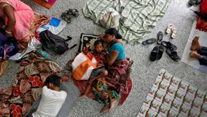 People rest on the floor outside the intensive care unit of the Baba Raghav Das hospital in Gorakhpur on August 14.(REUTERS) People rest on the floor outside the intensive care unit of the Baba Raghav Das hospital in Gorakhpur on August 14.(REUTERS)