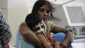 A woman with her son inside the encephalitis ward at the BRD medical centre in Gorakhpur, on Tuesday.(Deepak Gupta/ HT Photo) A woman with her son inside the encephalitis ward at the BRD medical centre in Gorakhpur, on Tuesday.(Deepak Gupta/ HT Photo)