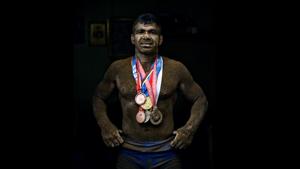 Deaf Olympic Gold medalist wrestler Virender Singh poses for a portrait with his medals at his akhara near Sadar Bazar in New Delhi.(Ravi Choudhary/HT PHOTO) Deaf Olympic Gold medalist wrestler Virender Singh poses for a portrait with his medals at his akhara near Sadar Bazar in New Delhi.(Ravi Choudhary/HT PHOTO)