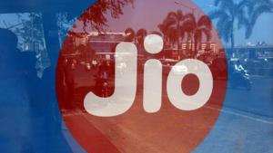 Commuters are reflected on an advertisement of Reliance Industries' Jio telecoms unit, at a bus stop in Mumbai.(REUTERS) Commuters are reflected on an advertisement of Reliance Industries' Jio telecoms unit, at a bus stop in Mumbai.(REUTERS)