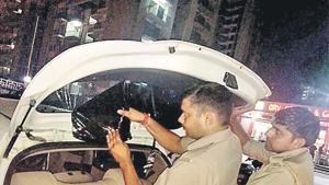 Cops removing black film from cars in Noida. Cops removing black film from cars in Noida.