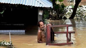 A man carries a table as he shifts to safe place from a flood-hit village in Araria district of Bihar on Monday.(PTI Photo) A man carries a table as he shifts to safe place from a flood-hit village in Araria district of Bihar on Monday.(PTI Photo)
