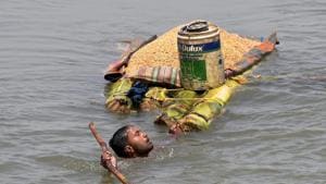 A villager carries grains on a banana raft as he shifts from a flooded village in Araria district of Bihar.(PTI File Photo) A villager carries grains on a banana raft as he shifts from a flooded village in Araria district of Bihar.(PTI File Photo)