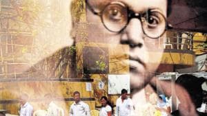 People are reflected on the glass of a framed photograph of Bhimrao Ambedkar, as they visit a memorial dedicated to him, on his birth anniversary in Mumbai on April 14, 2016.(AP File Photo)