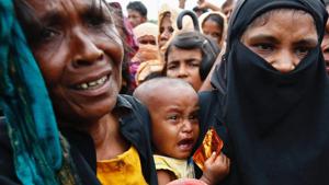 A Rohingya refugee baby cries as his mother jostles for aid in Cox's Bazar, Bangladesh.(Reuters Photo) A Rohingya refugee baby cries as his mother jostles for aid in Cox's Bazar, Bangladesh.(Reuters Photo)