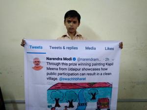 In the painting, Kapil Meena displayed a few people cleaning their village and throwing litter in dustbins(HT Photo) In the painting, Kapil Meena displayed a few people cleaning their village and throwing litter in dustbins(HT Photo)