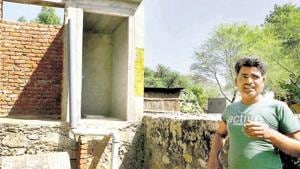 A man shows the incomplete toilet and bathroom at his house in a village in the outskirts of Jaipur.(Himanshu Vyas/HT Photo) A man shows the incomplete toilet and bathroom at his house in a village in the outskirts of Jaipur.(Himanshu Vyas/HT Photo)