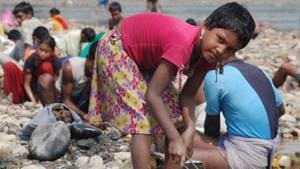 A slum girl searches for valuable items on the Ganga bank in Haridwar.(HT Photo) A slum girl searches for valuable items on the Ganga bank in Haridwar.(HT Photo)