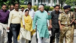 RJD leader and former railway minister Lalu Prasad, accompanied by his daughter Misa, arrives at the CBI headquarters in New Delhi on Thursday for questioning.(PTI Photo)
