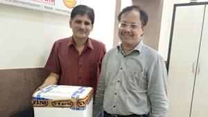 Divya mother milk bank staff and Devendra Jain (right) taking 48 units of mother milk in ice pack to Ahmedabad.(HT PHOTO)