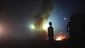A child stands in front of smoke emitted from burning firecrackers in east Delhi on Diwali night.(Ravi Choudhary / HT PHOTO) A child stands in front of smoke emitted from burning firecrackers in east Delhi on Diwali night.(Ravi Choudhary / HT PHOTO)