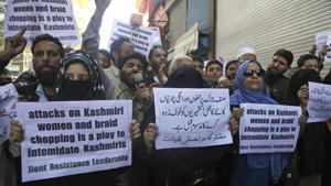 A file photo shows Kashmiri separatists holding placards as they protest against increasing incidents of alleged braid chopping in Srinagar.(AP) A file photo shows Kashmiri separatists holding placards as they protest against increasing incidents of alleged braid chopping in Srinagar.(AP)