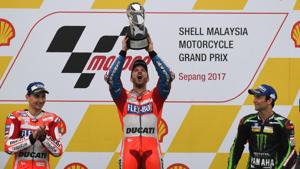 Ducati rider Andrea Dovizioso (C) celebrates his victory with second-placed Jorge Lorenzo (L) and third-placed Johann Zarco (R) on the podium after winning the Malaysia MotoGP at the Sepang International Circuit on Sunday.(AFP) Ducati rider Andrea Dovizioso (C) celebrates his victory with second-placed Jorge Lorenzo (L) and third-placed Johann Zarco (R) on the podium after winning the Malaysia MotoGP at the Sepang International Circuit on Sunday.(AFP)