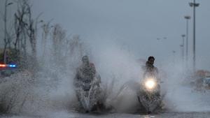 People ride their bikes through a waterlogged service road near Marina beach in Chennai on Monday.(PTI) People ride their bikes through a waterlogged service road near Marina beach in Chennai on Monday.(PTI)