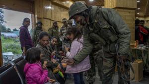 An army soldier offers juice to a child after she was rescued from a cable car in Gulmarg, Kashmir, in June 2017. The army was called in to help with rescue efforts after a cable car came crashing down from a height of at least 100 feet in the tourist resort of Gulmarg, leaving scores of tourists stranded.(AP File Photo) An army soldier offers juice to a child after she was rescued from a cable car in Gulmarg, Kashmir, in June 2017. The army was called in to help with rescue efforts after a cable car came crashing down from a height of at least 100 feet in the tourist resort of Gulmarg, leaving scores of tourists stranded.(AP File Photo)