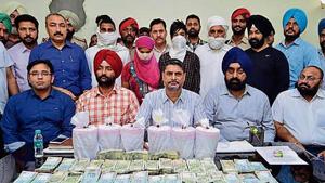 Special task force members along with other officials showing the recovered cash and over 90 kg contraband in Amritsar.(HT File) Special task force members along with other officials showing the recovered cash and over 90 kg contraband in Amritsar.(HT File)