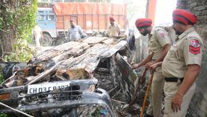 Police officials looking at the burnt car at Chahru police station opposite Lovely Professional University near Jalandhar on Monday.(Pardeep Pandit/HT) Police officials looking at the burnt car at Chahru police station opposite Lovely Professional University near Jalandhar on Monday.(Pardeep Pandit/HT)