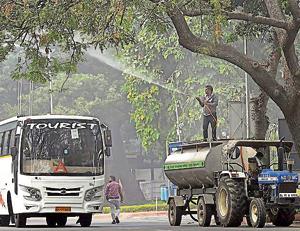An NDMC worker sprays water on a tree to settle dust as part of the measure against pollution, in New Delhi on Monday. Delhi fire services on Wednesday followed the order by sprinkling water from Vikas Minar at ITO. The spraying, which was started around 4pm, was done for nearly an hour.(PTI) An NDMC worker sprays water on a tree to settle dust as part of the measure against pollution, in New Delhi on Monday. Delhi fire services on Wednesday followed the order by sprinkling water from Vikas Minar at ITO. The spraying, which was started around 4pm, was done for nearly an hour.(PTI)
