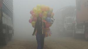 A Pakistani vendor carries balloons on a street amid heavy smog in Lahore. NOAA released satellite pictures and explained the reasons behind such a polluting atmosphere in major parts of north India and Pakistan.(AFP File Photo) A Pakistani vendor carries balloons on a street amid heavy smog in Lahore. NOAA released satellite pictures and explained the reasons behind such a polluting atmosphere in major parts of north India and Pakistan.(AFP File Photo)