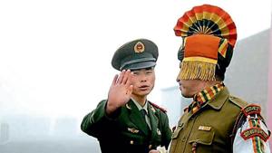 A Chinese soldier gestures next to an Indian soldier at the Nathu La border crossing in Sikkim.(AFP File Photo) A Chinese soldier gestures next to an Indian soldier at the Nathu La border crossing in Sikkim.(AFP File Photo)