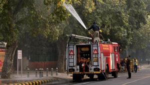A firefighter sprays water on trees as part of the anti-pollution measures to improve air quality in Delhi on Thursday.(PTI) A firefighter sprays water on trees as part of the anti-pollution measures to improve air quality in Delhi on Thursday.(PTI)