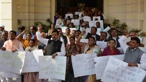 Opposition legislators protesting outside the Bihar legislative assembly building in Patna.(Santosh Kumar/HT photo)