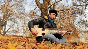 Nazir Ganaie, a Srinagar-based government employee and music aficionado, plays his rabab, which is carved out of mulberry wood.(HT Photo/Waseem Andrabi) Nazir Ganaie, a Srinagar-based government employee and music aficionado, plays his rabab, which is carved out of mulberry wood.(HT Photo/Waseem Andrabi)