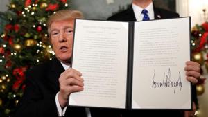 US President Donald Trump holds up the proclamation that announces the United States recognising Jerusalem as the capital of Israel and moving its embassy there, during an address from the White House in Washington.(Reuters) US President Donald Trump holds up the proclamation that announces the United States recognising Jerusalem as the capital of Israel and moving its embassy there, during an address from the White House in Washington.(Reuters)