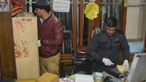 Police inspect weapons in a Uttar Pradesh shop from where arms were looted. Police inspect weapons in a Uttar Pradesh shop from where arms were looted.