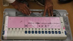A polling official checks an electronic voting machine at a dispatch center before proceeding to his allotted station for the second phase of voting for the Gujarat assembly elections in Ahmedabad.(AP Photo) A polling official checks an electronic voting machine at a dispatch center before proceeding to his allotted station for the second phase of voting for the Gujarat assembly elections in Ahmedabad.(AP Photo)