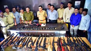 Nashik rural police with the seized arms near Chandwad toll naka on Agra-Mumbai highway.(HT PHOTO) Nashik rural police with the seized arms near Chandwad toll naka on Agra-Mumbai highway.(HT PHOTO)