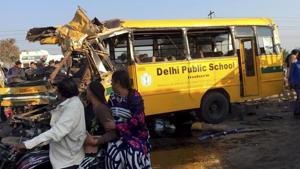 Passers-by look at the school bus that was wrecked due to an accident, in Indore on Friday.(PTI Photo) Passers-by look at the school bus that was wrecked due to an accident, in Indore on Friday.(PTI Photo)