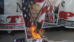 Pakistani protesters burn banners of US President Donald Trump during a demonstration.(AP Photo) Pakistani protesters burn banners of US President Donald Trump during a demonstration.(AP Photo)