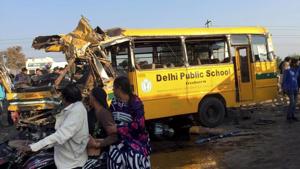 Passers-by look at the wrecked school bus involved in an accident in Indore on Friday.(PTI) Passers-by look at the wrecked school bus involved in an accident in Indore on Friday.(PTI)