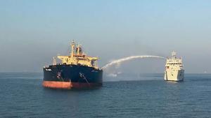 A ship douses the flame and cools off the temperature of M T Genessa in Kandla on Thursday.(PTI Photo) A ship douses the flame and cools off the temperature of M T Genessa in Kandla on Thursday.(PTI Photo)