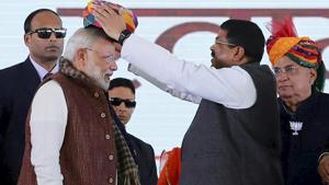 Prime minister Narendra Modi being presented a turban at a rally in Barmer.(PTI) Prime minister Narendra Modi being presented a turban at a rally in Barmer.(PTI)