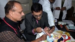 JK Lone Hospital Medical Superintendent Dr Ashok Gupta (left) with Newborn Screening Laboratory in-charge Dr Priyanshu Mathur on Monday.(Prabhakar Sharma/HT PHOTO)