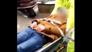 Paramedics lift the man and secure him to a stretcher(Screengrab/Youtube)