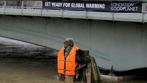 A banner hangs from the Pont d'Alma bridge with the message, A banner hangs from the Pont d'Alma bridge with the message,