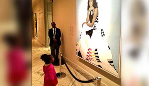 Toddler seen admiring Michelle Obama’s portrait (Facebook) Toddler seen admiring Michelle Obama’s portrait (Facebook)