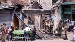 Sri Lanka's Special Task Force and police officers stand guard near a burnt house after a clash between two communities in Digana, central district of Kandy, on Tuesday.(Reuters) Sri Lanka's Special Task Force and police officers stand guard near a burnt house after a clash between two communities in Digana, central district of Kandy, on Tuesday.(Reuters)