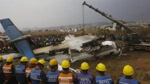 Rescuers and police are seen near the debris after a passenger plane from Bangladesh crashed at the airport in Kathmandu, Nepal.(AP Photo) Rescuers and police are seen near the debris after a passenger plane from Bangladesh crashed at the airport in Kathmandu, Nepal.(AP Photo)
