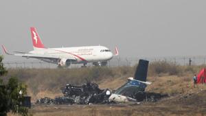 Remains of Bangladesh's US-Bangla Flight BS211 on the ground at the Tribhuvan International Airport in Kathmandu, Nepal, on Tuesday. The crash at Nepal's main airport killed 49 of the 71 people on board, and police said Tuesday an investigation was ordered into the cause of the accident, after news came out that confusion over landing instructions led to the crash as the plane flew low and became unstable before hitting the ground and bursting into flames. Bangladesh cricket team players will wear a black armband during their Nidahas Trophy match vs Indian cricket team to honour the crash victims.(AP) Remains of Bangladesh's US-Bangla Flight BS211 on the ground at the Tribhuvan International Airport in Kathmandu, Nepal, on Tuesday. The crash at Nepal's main airport killed 49 of the 71 people on board, and police said Tuesday an investigation was ordered into the cause of the accident, after news came out that confusion over landing instructions led to the crash as the plane flew low and became unstable before hitting the ground and bursting into flames. Bangladesh cricket team players will wear a black armband during their Nidahas Trophy match vs Indian cricket team to honour the crash victims.(AP)